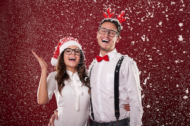 Happy Nerd Couple Surrounded by Snowflakes – Free Stock Photo Download
