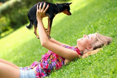 Happy Woman and Her Dog Enjoying a Sunny Day on the Grass – Free Stock Photo, Download for Free