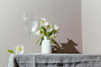 Glass of Water and Flowers on Table – Free Stock Photo for Download