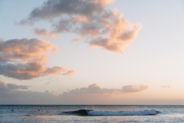 Stunning Sunset Over Ocean with White Clouds | Free Download