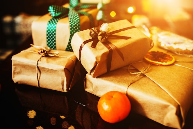 Stacked Gifts with Green Bows and an Orange – Free Stock Photo, Download Free