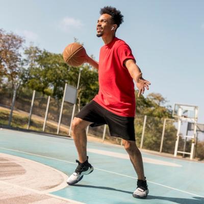 Dynamic Man Playing Basketball on a Field – Free to Download