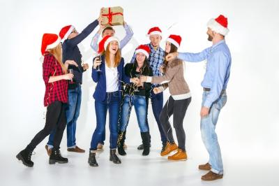 Young Men and Women Celebrating at a Christmas Party – Free Download