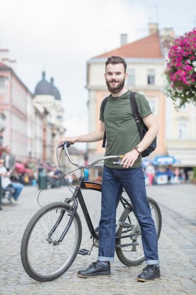 Portrait of a Man with His Bicycle Looking at Camera – Free to Download