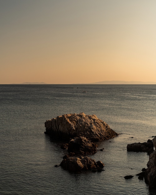 Rocks of Varying Sizes in the Sea Under a Clear Sky – Free Download