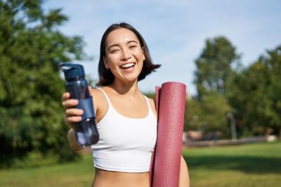 Happy Asian Girl Fitness Woman Offering Water Bottle After Workout – Free Download