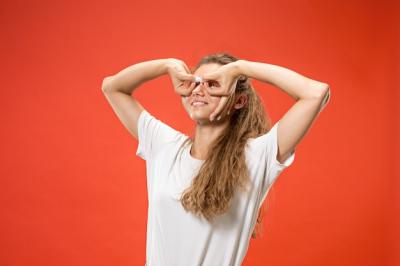 Happy Woman Smiling Against a Red Background – Free Stock Photo Download