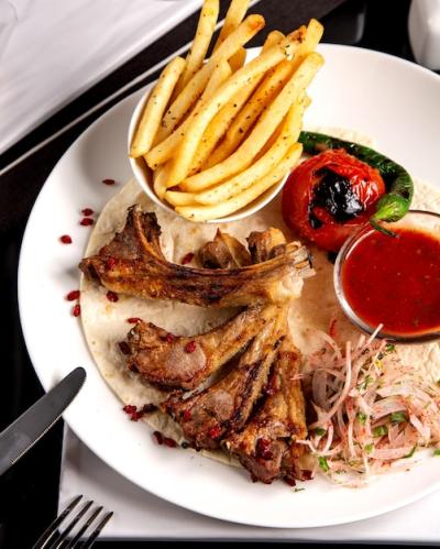 Delicious Lamb Ribs Kebab with French Fries, Onions, Tomato Sauce, and Grilled Vegetables – Free Stock Photo, Download for Free