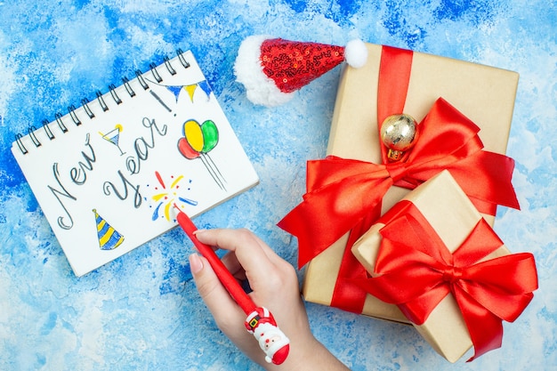 Holiday Gifts and Santa Hat on Notepad – Free Download