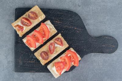 Crispy Toasts with Tomatoes on a Black Wooden Board – Free Download