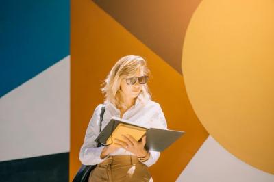 Young Businesswoman Reading a Book Against Wallpaper – Free Stock Photo, Download Free