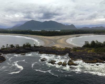 Aerial Shot of a Serene Sea Surrounded by Majestic Rocks and Mountains – Free Download