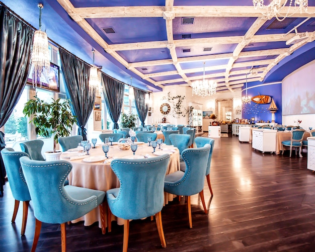 Restaurant Hall Featuring Blue Chairs and Decorative Wall Art – Free Download