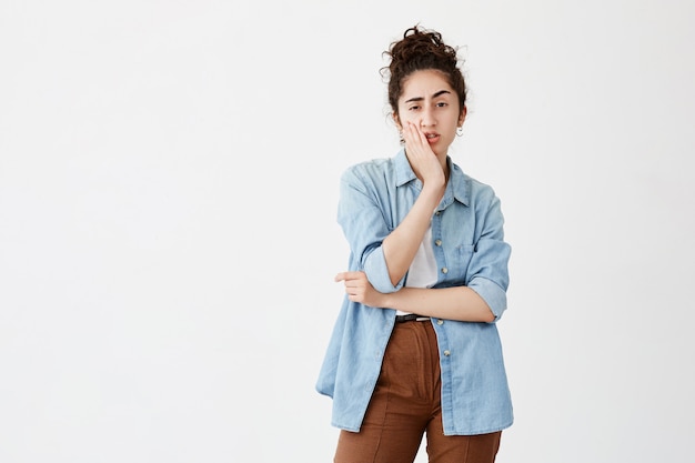 Troubled Young Woman with Dark Hair in Denim Shirt Pondering Life Decisions – Free Download