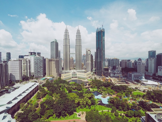 Petronas Twin Towers Surrounded by Skyscrapers and Lush Trees in Kuala Lumpur, Malaysia – Free Stock Photo for Download