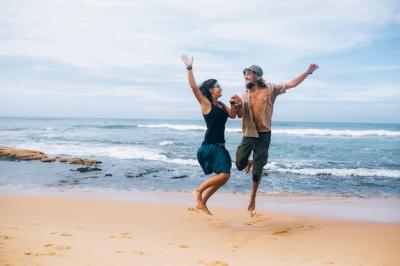 Happy Couple Jumping on the Shore – Free Download