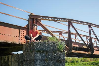 Young Lonely Male Hiker Sitting Near Bridge – Free Stock Photo for Download