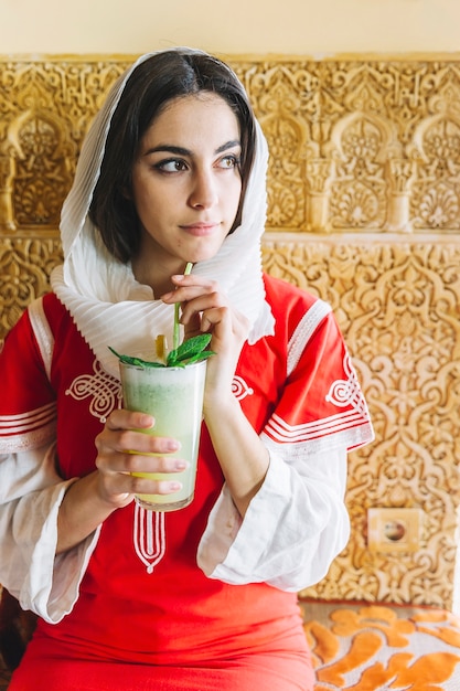 Muslim Woman Enjoying a Delicious Drink – Free Stock Photo for Download