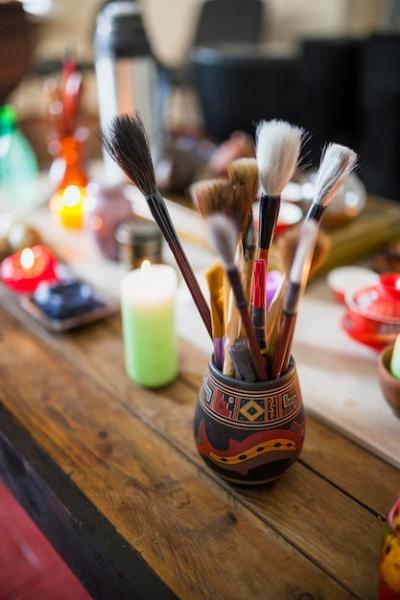 Chinese Paint Brushes in Holder on Wooden Table with Lighted Candles – Free Stock Photo for Download