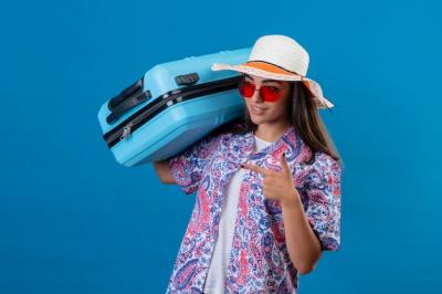 Young Beautiful Woman Tourist in Summer Hat and Red Sunglasses with Travel Suitcase – Free Download