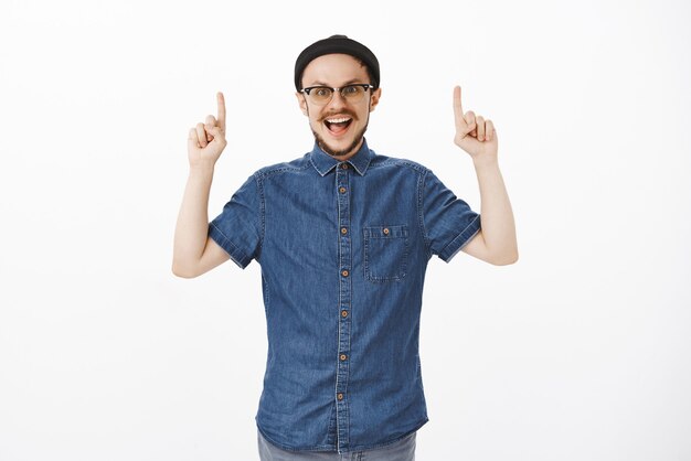 Joyful European Male with Beard in Glasses and Beanie Celebrating Travel Excitement – Free Download