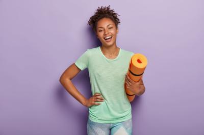 Positive Afro Woman Working Out at Home with Orange Karemat – Free Stock Photo for Download