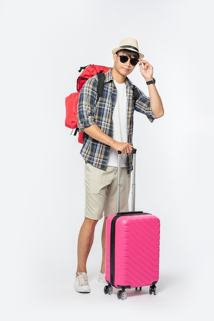 Men Traveling in Style: Glasses, Hats, and Luggage – Free Stock Photo