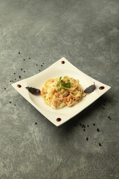 A Plate of Fettuccini with Chicken on a Plain Grey Background – Free Stock Photo, Download Free