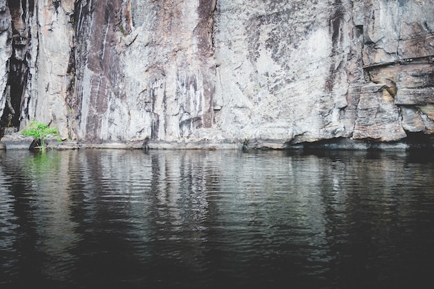 Stunning Rocky Cliff by a Tranquil Lake – Free Stock Photo, Download for Free