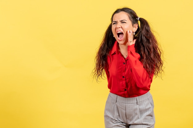 Young Girl in Red Blouse Calling Out on Yellow Background – Free Download