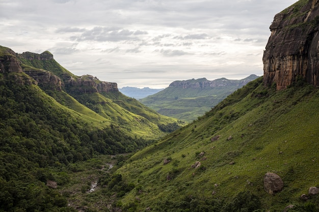 Stunning Green Valley Surrounded by High Rocks and Steep Hills â Free to Download