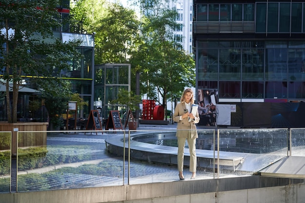 Confident Corporate Woman in Beige Suit with Working Documents – Free Stock Photo for Download