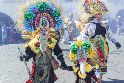 A Participant in Carnival in Huejotzingo Wearing Traditional Dress Dancing – Free Download