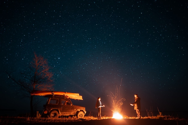 Happy Couple Enjoying a Bonfire – Free Stock Photo for Download