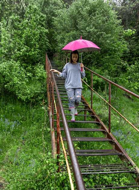 A girl with an umbrella walks in the woods in rainy weather – Free Stock Photo, Download for Free