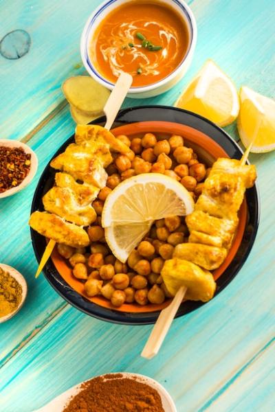 Chickpea and Chicken Kebab Surrounded by Condiments – Free Download