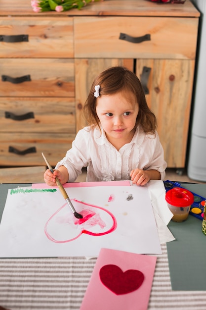 Little Girl Painting a Heart on Paper – Free Stock Photo for Download