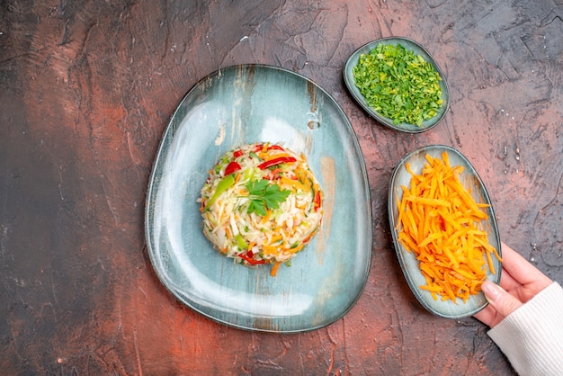 Delicious Top View of Tasty Vegetable Salad with Greens and Carrots on Dark Table – Free Stock Photo for Download