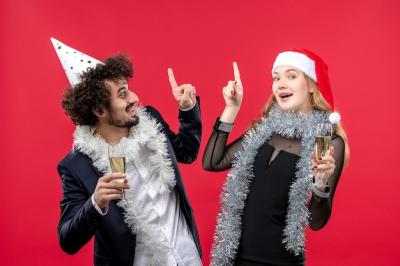 Young Happy Couple Celebrating New Year in Front of a Red Wall | Free Stock Photo, Download Free Stock Photo