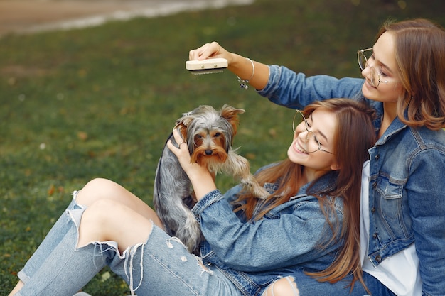 Cute Girls Playing with a Little Dog in the Park – Free Download