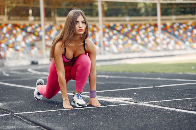 Sports Girl in Pink Uniform Running at the Stadium – Free Stock Photo, Download for Free