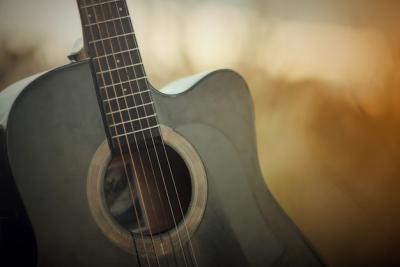 Acoustic Guitar in a Sunset Meadow Landscape – Free Stock Photo for Download