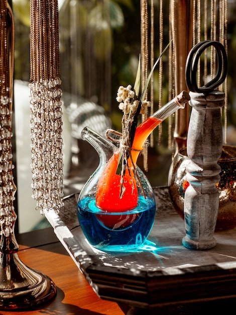 Unique Two-Part Beverage Jug Filled with Vibrant Orange and Blue Cocktails – Free Download