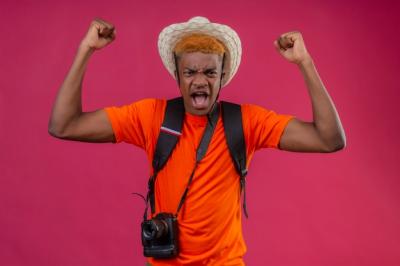 Handsome Boy in Summer Hat with Camera and Angry Expression – Free Stock Photo for Download