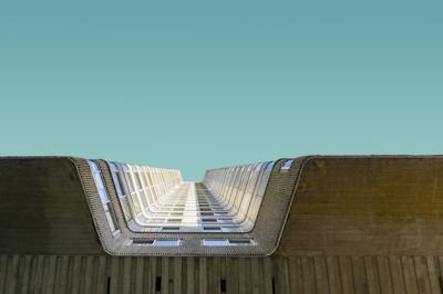 Low Angle Shot of a Tall Brick Building Against a Clear Blue Sky – Free Stock Photo, Download for Free