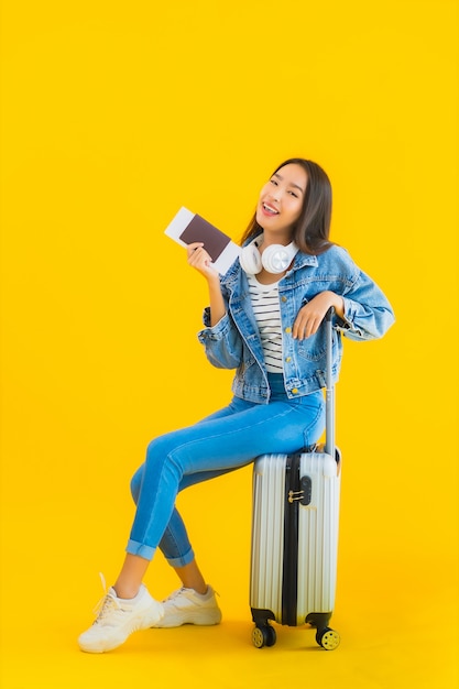 Young Asian Woman Traveling with Luggage and Passport – Free Download