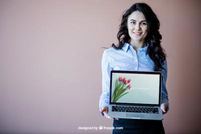 Elegant Business Woman Presenting Laptop – Free Download