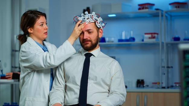 Neurologist Analyzing Brain and Nervous System with Advanced Brainwave Scanning  Headset – Free Stock Photo for Download