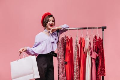 Dark-haired Woman with Red Lipstick Smiling Against a Pink Background – Free Download