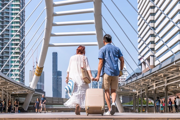 Young Asian Couple Walking with Luggage for Summer Vacation or Honeymoon Trip – Free Download